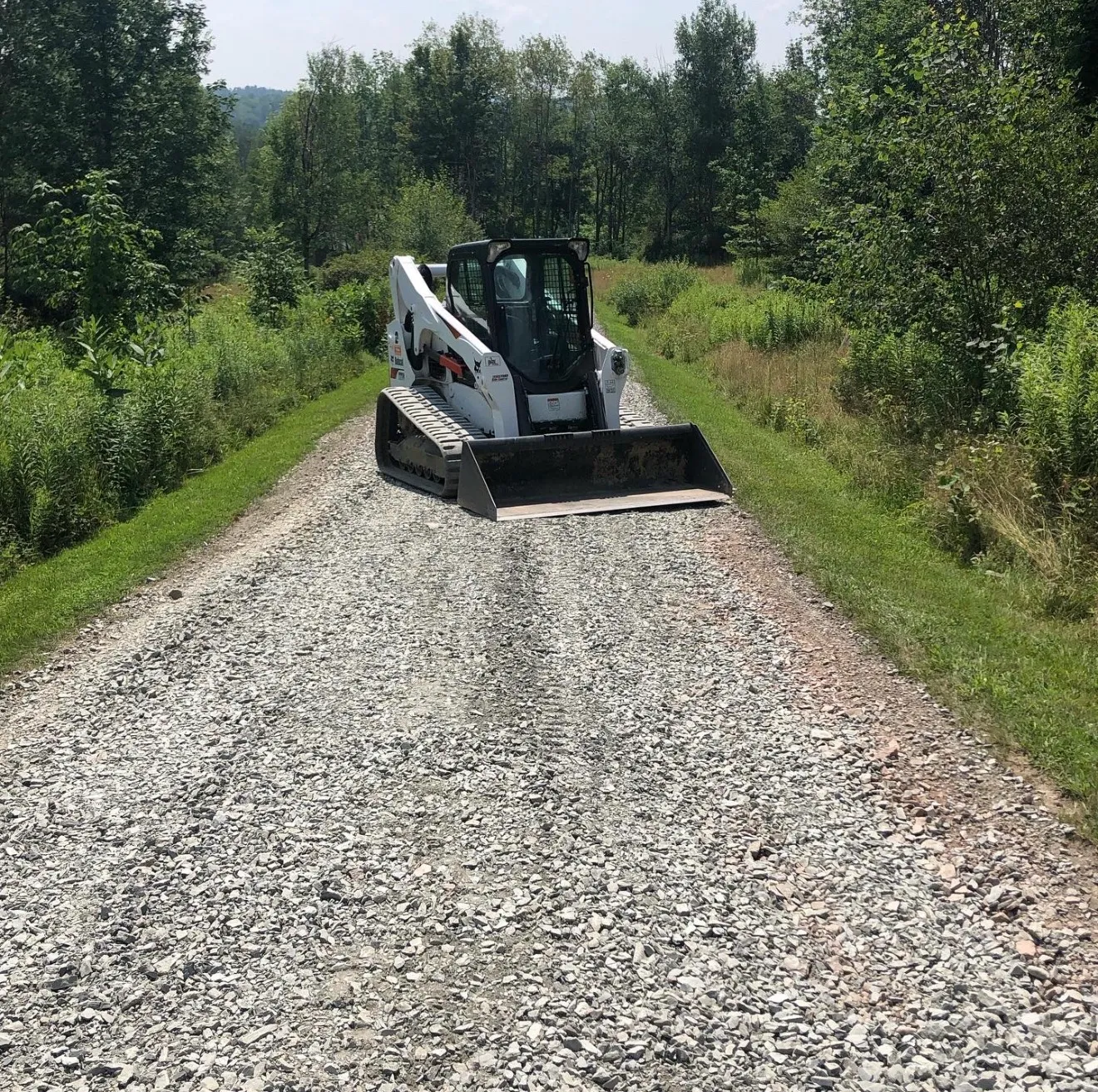 Skilled operator using modern excavator for precise trenching near Lawrenceville, PA business district