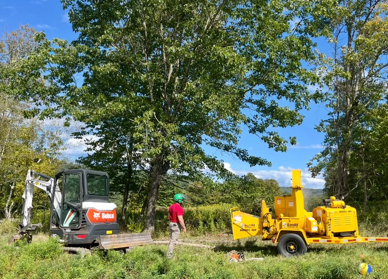 Crew operating excavator and grading land for a new home build in Ulysses, PA during spring